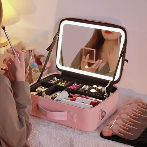 Pink make-up case open, its mirror lit
